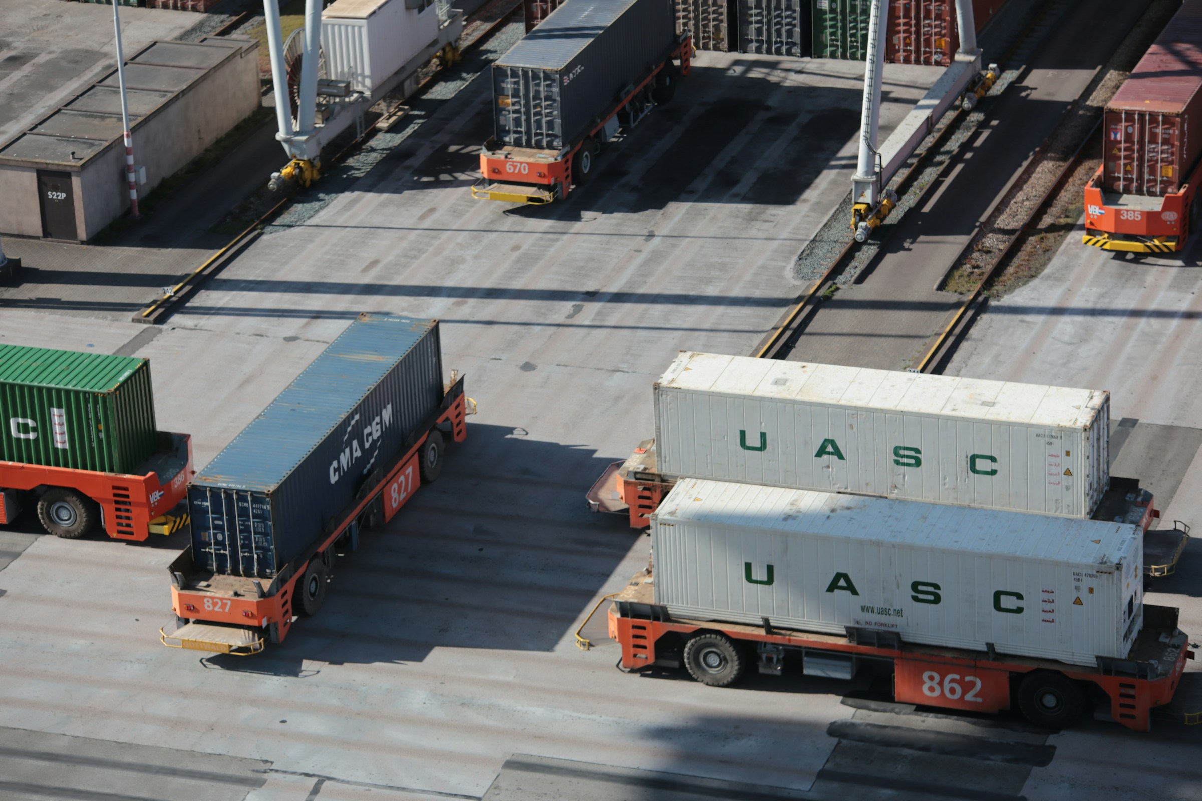 Freight vehicles moving containers at the Port of Rotterdam